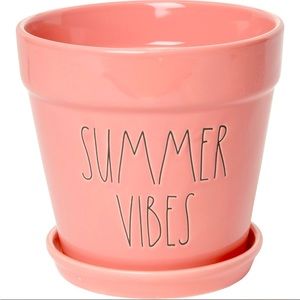 Rae Dunn "Summer Vibes" cylinder planter adds a touch of color to any decor.